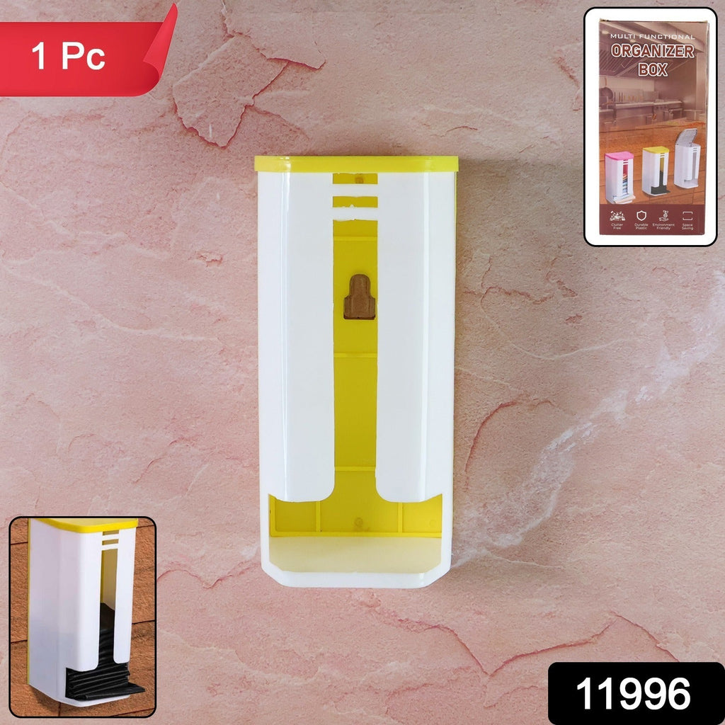 Compact plastic bag organizer box mounted on a kitchen wall, saving space.