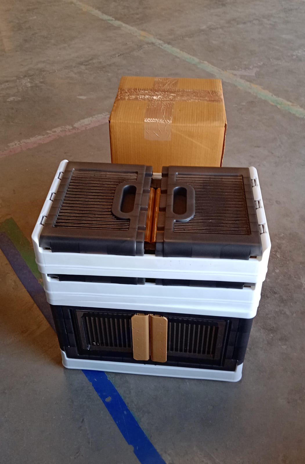 Collapsible plastic storage box folded flat for space-saving storage