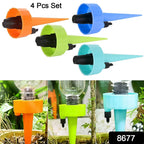 Four automatic plant watering devices inserted into potted plants.