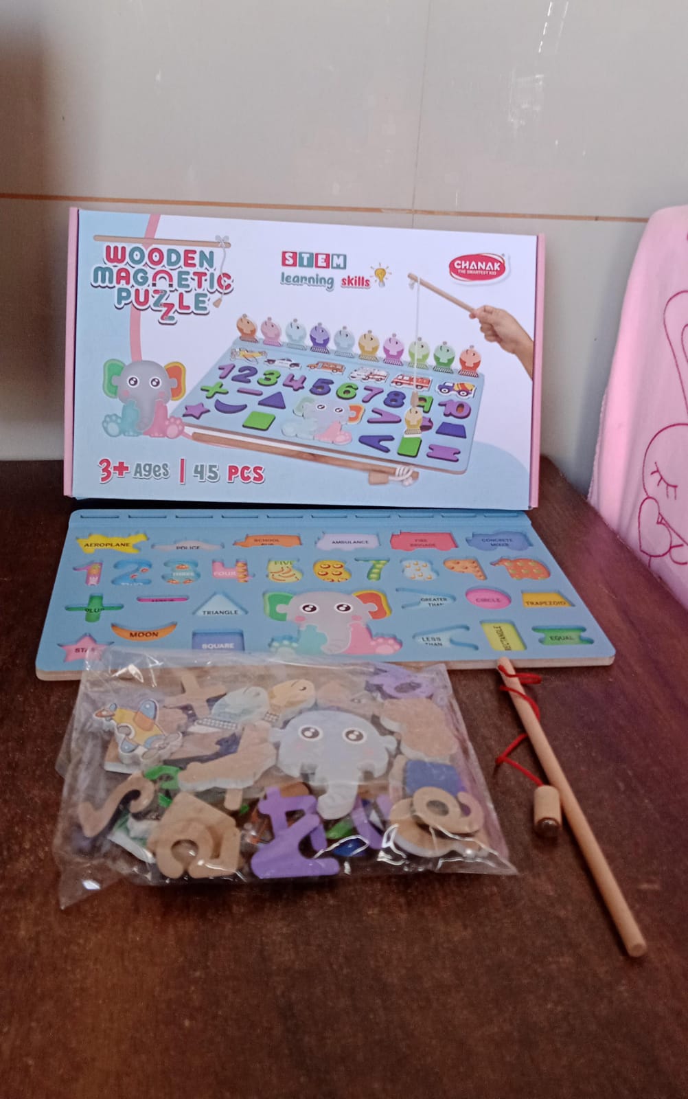 Neatly stacked wooden number pieces from the learning number puzzle set.