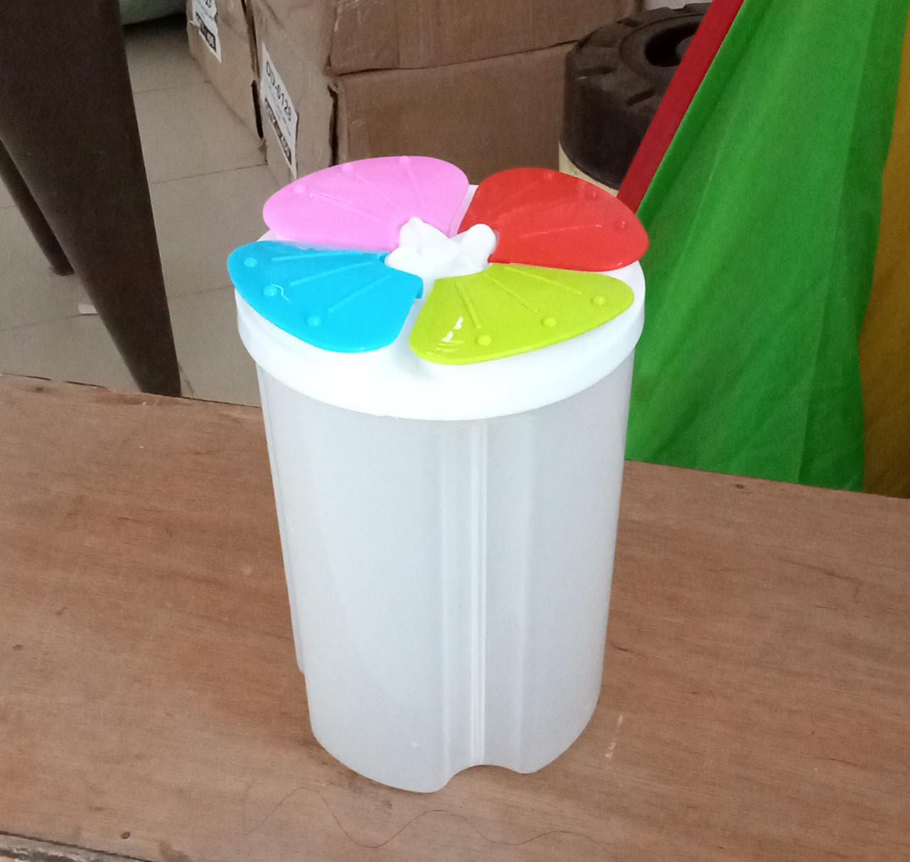 An empty Organivo 4 section kitchen storage jar, showing its clear plastic and the internal dividers for versatile organisation.