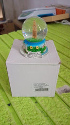 Another angle of the decorative snow globe, showcasing its appeal as a unique gift item.