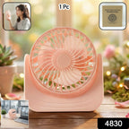 Compact silent mini desk fan placed on a wooden office desk