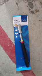 Hand holding the compact magnetic pick up tool.