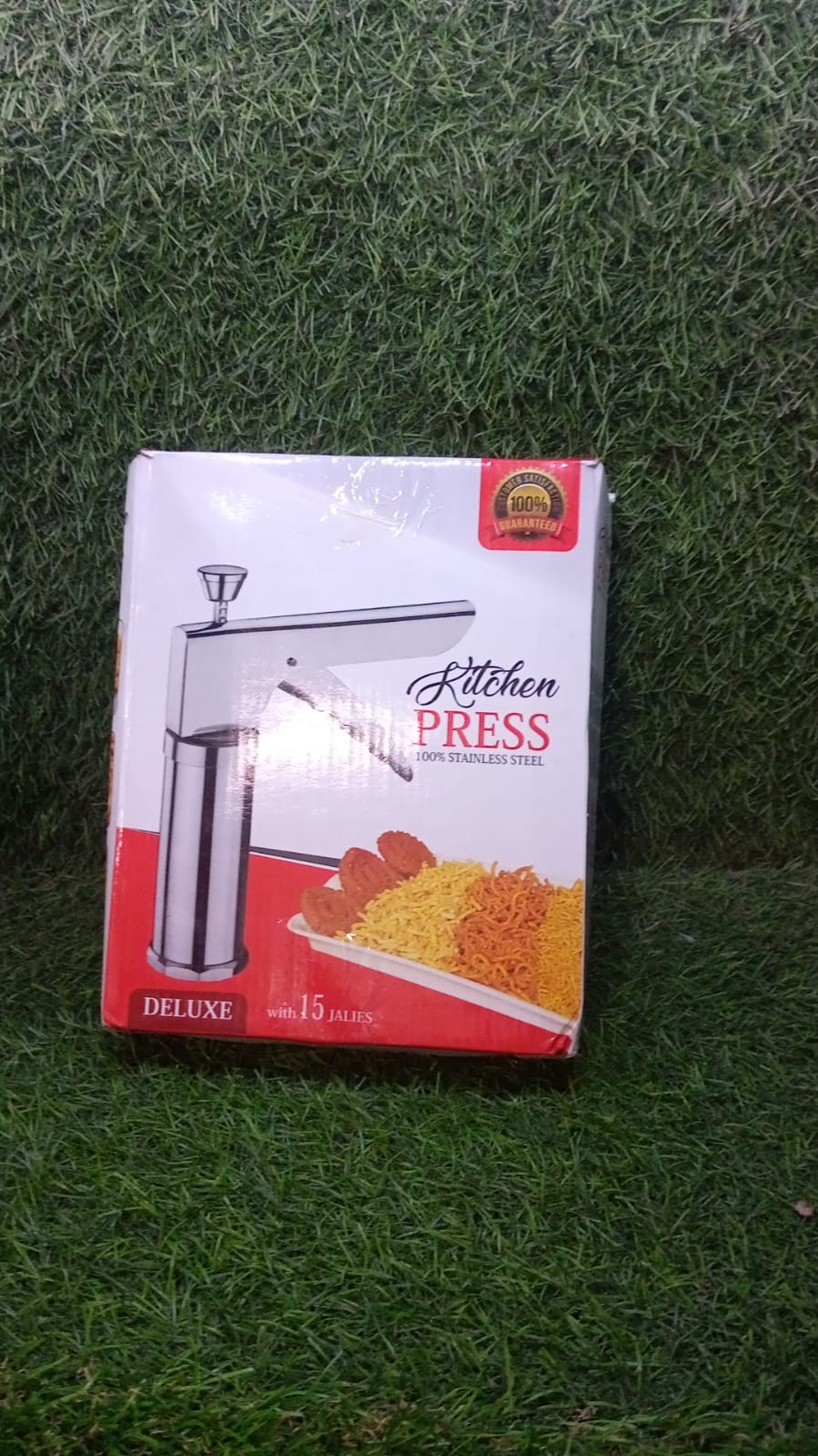 Stainless steel kitchen press displayed with all 15 attachments for various snacks.
