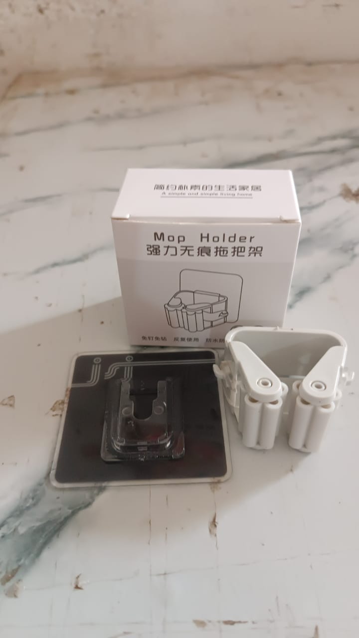 Strong adhesive backing of the wall mounted broom holder for easy installation.