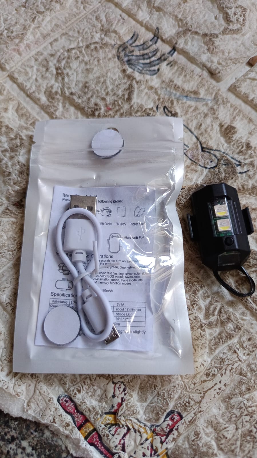 Mini RGB LED strobe light discreetly mounted on a bike frame for enhanced safety.