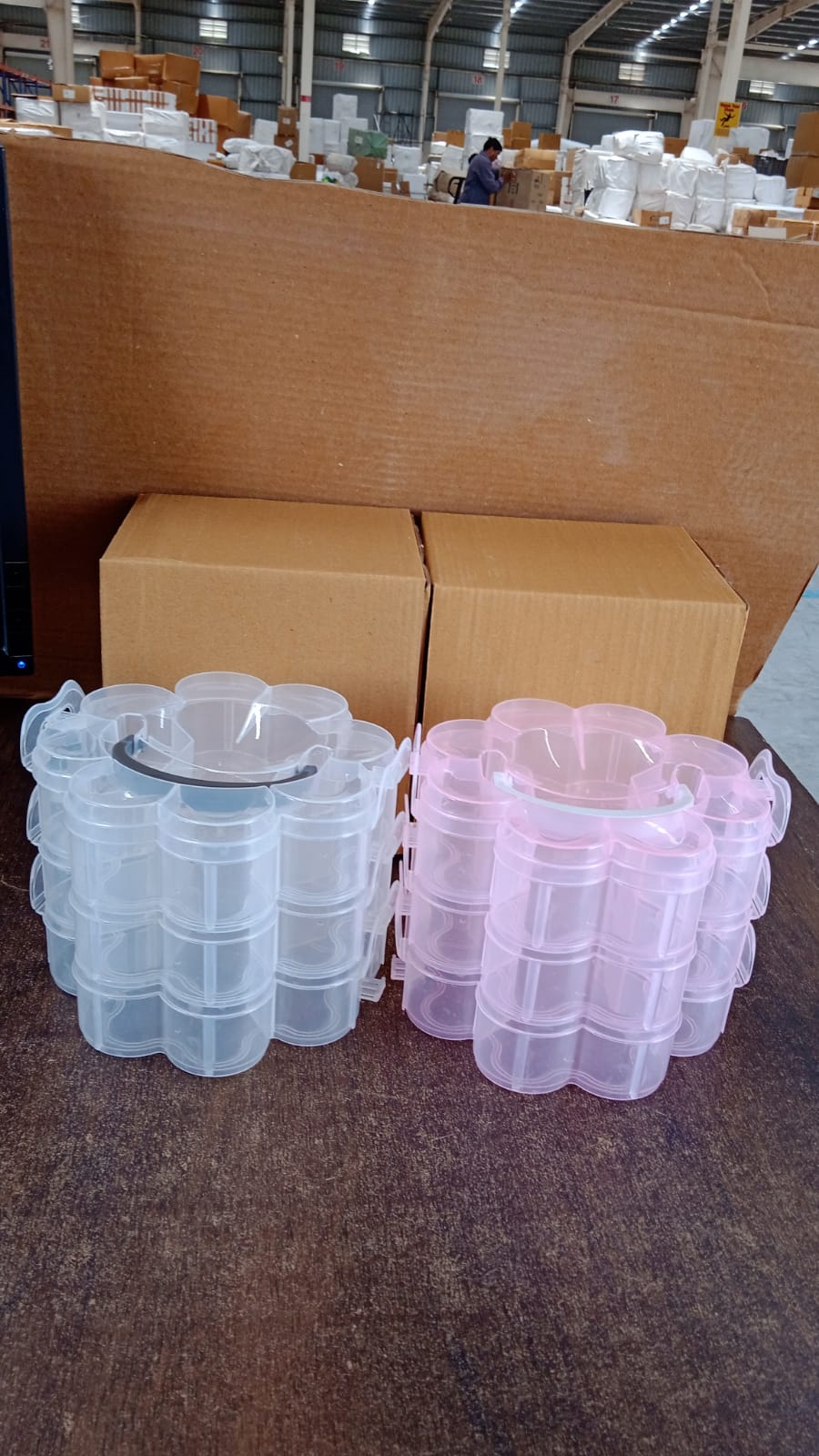 Close-up of transparent flower-shaped 3-layer storage box from India