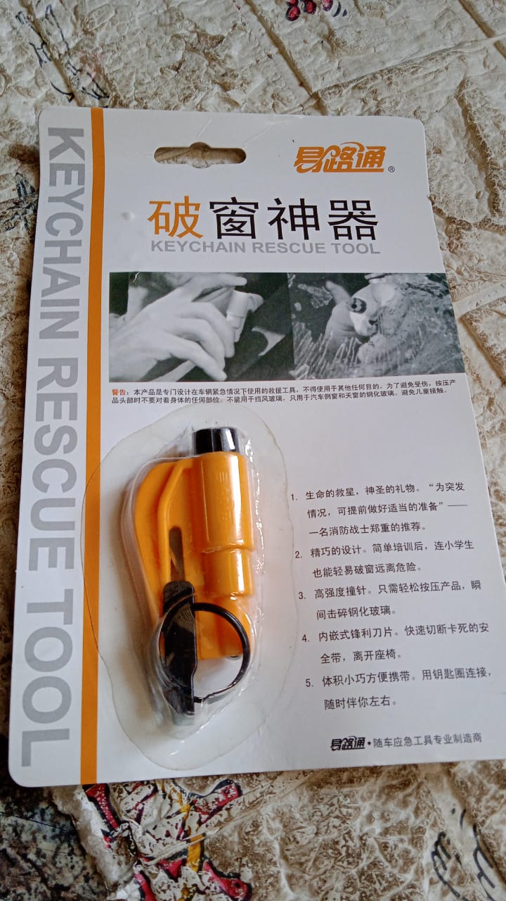 Emergency Safety Cutter keychain shown next to car keys for scale and portability.