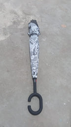 Lifestyle shot of the compact reverse umbrella being carried effortlessly.