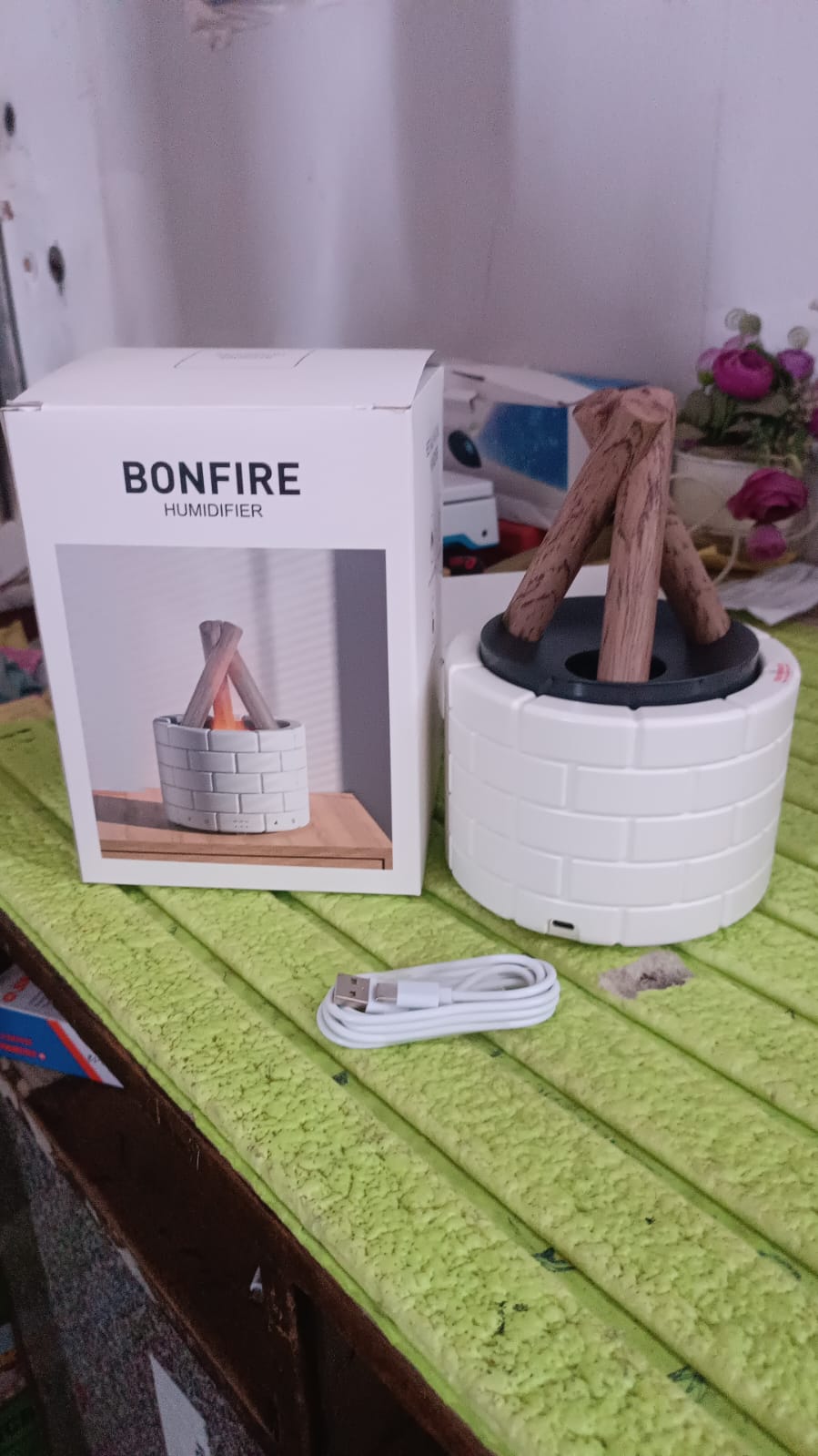 Flame Diffuser creating a warm ambiance on a bedside table with soft lighting.