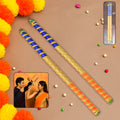 Decorative dandiya sticks pair with colorful golden accents for Navratri and Garba celebrations