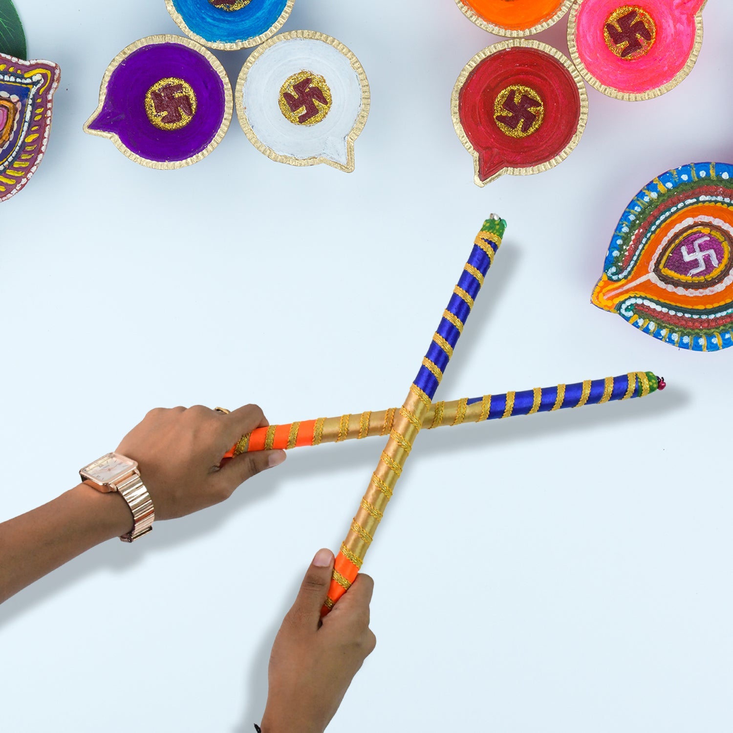 Close-up view of decorative dandiya sticks with intricate festive designs