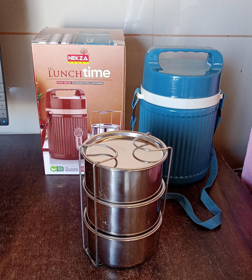 An insulated stainless steel dabba on a table, ready for a healthy meal.