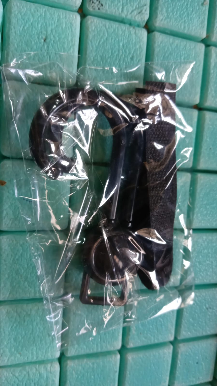 Stroller hook product showcasing its compact size and design.