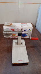 Angled view of the Quickslice stainless steel coconut scraper, highlighting its design.