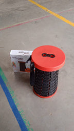 Close-up of the robust plastic material and sturdy construction of the retractable folding stool.