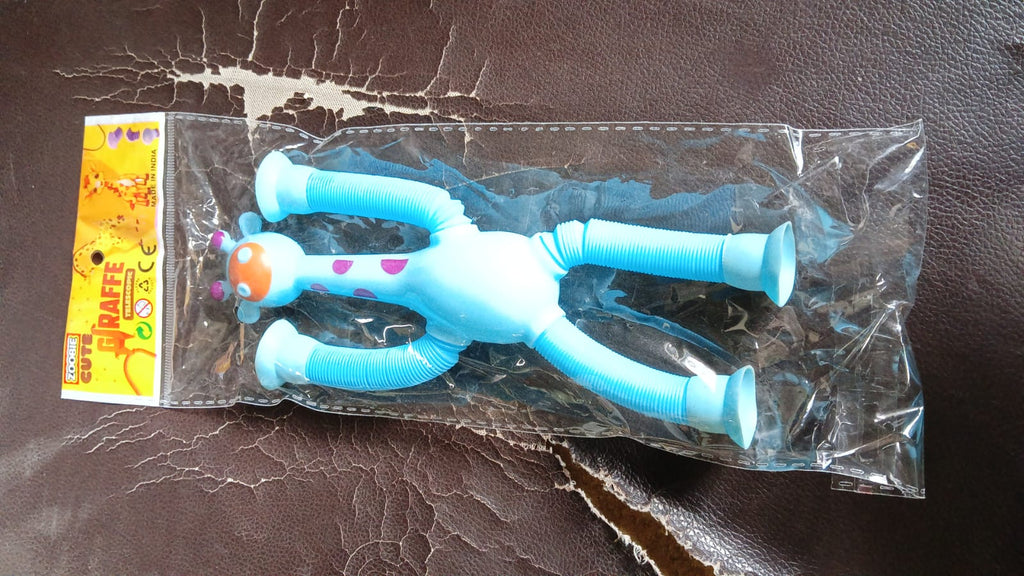 Close-up of the LED giraffe fidget toy's flexible body and suction cup feet.