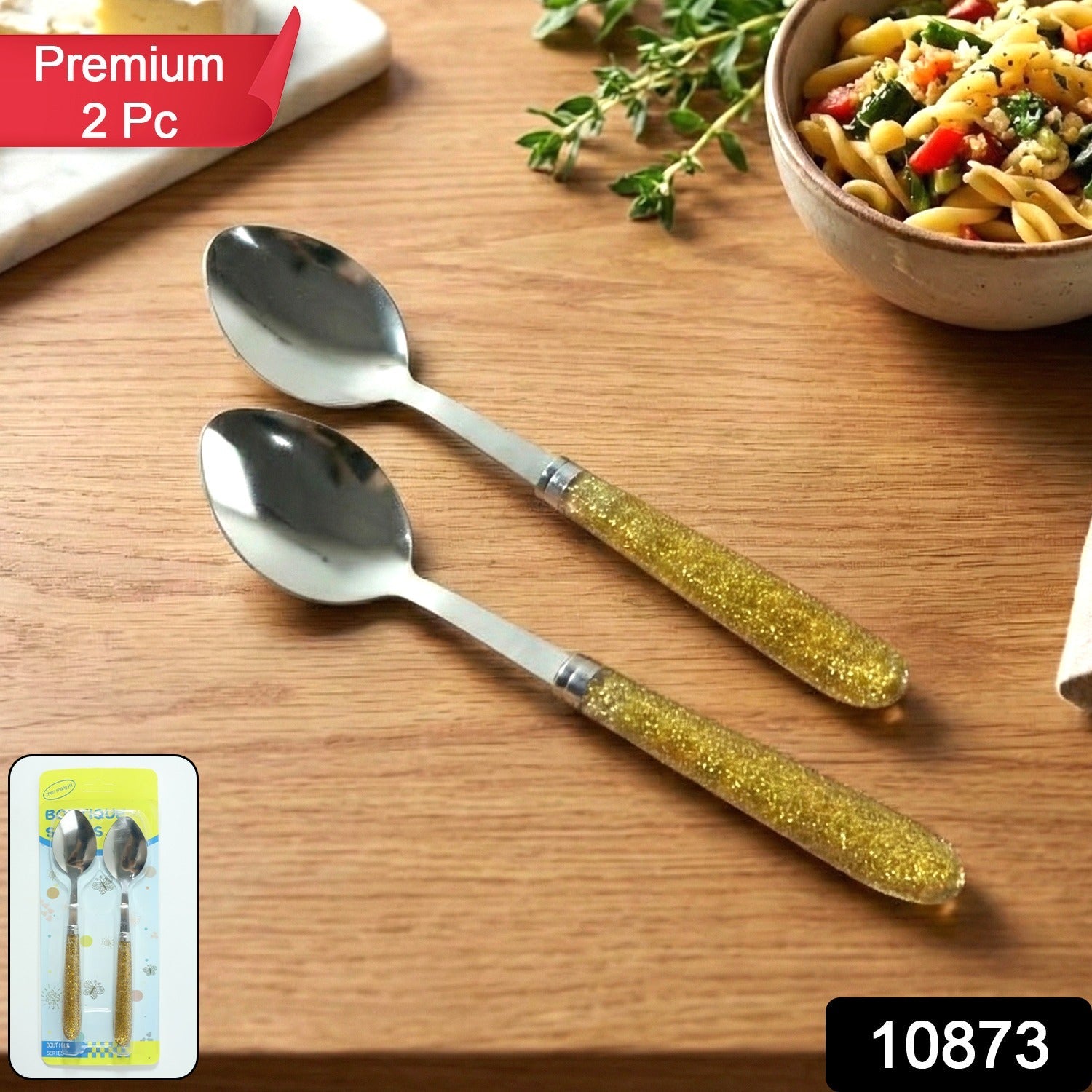 Close-up of two glitter handle stainless steel spoons in the dining set