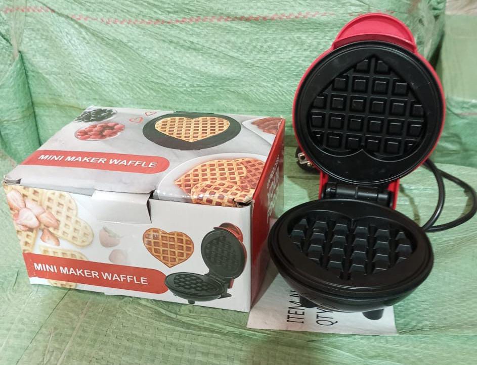 Mini waffle maker cooking freshly made waffles