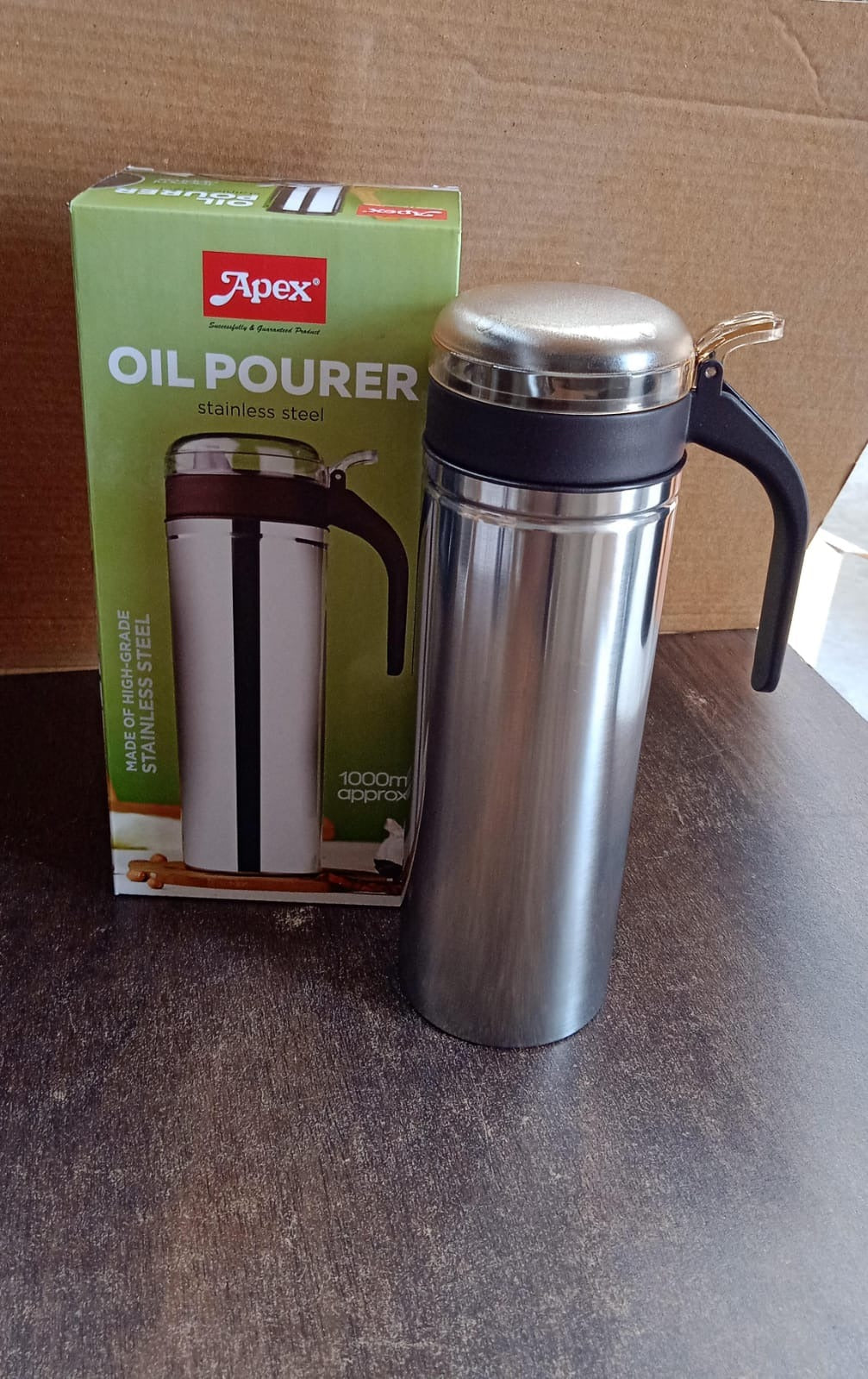 Full height view of stainless steel oil pourer showcasing sleek design
