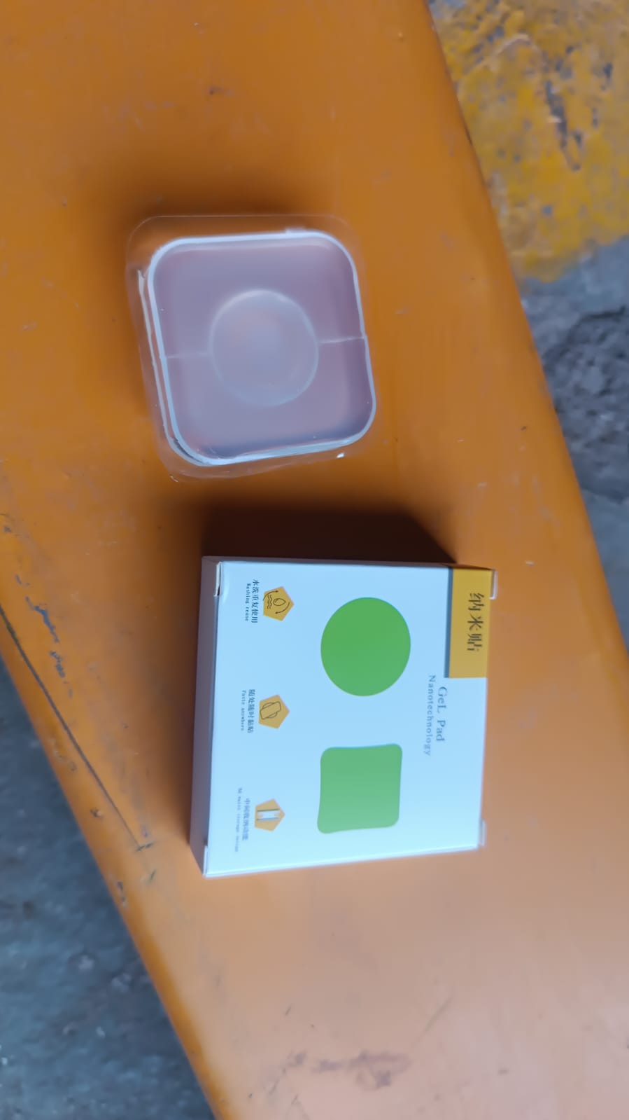 Nano gel pad holding a small item like a remote control vertically on a wall.