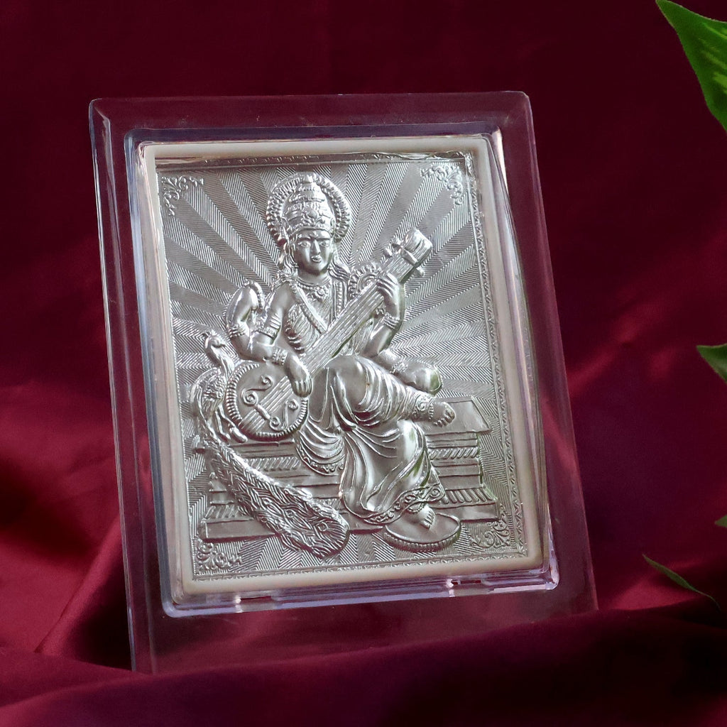 Top-down view of silver Saraswati Maa photo frame highlighting embossed design