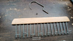 Organivo 8-hook wooden hanger specifically designed for organizing ties and belts.