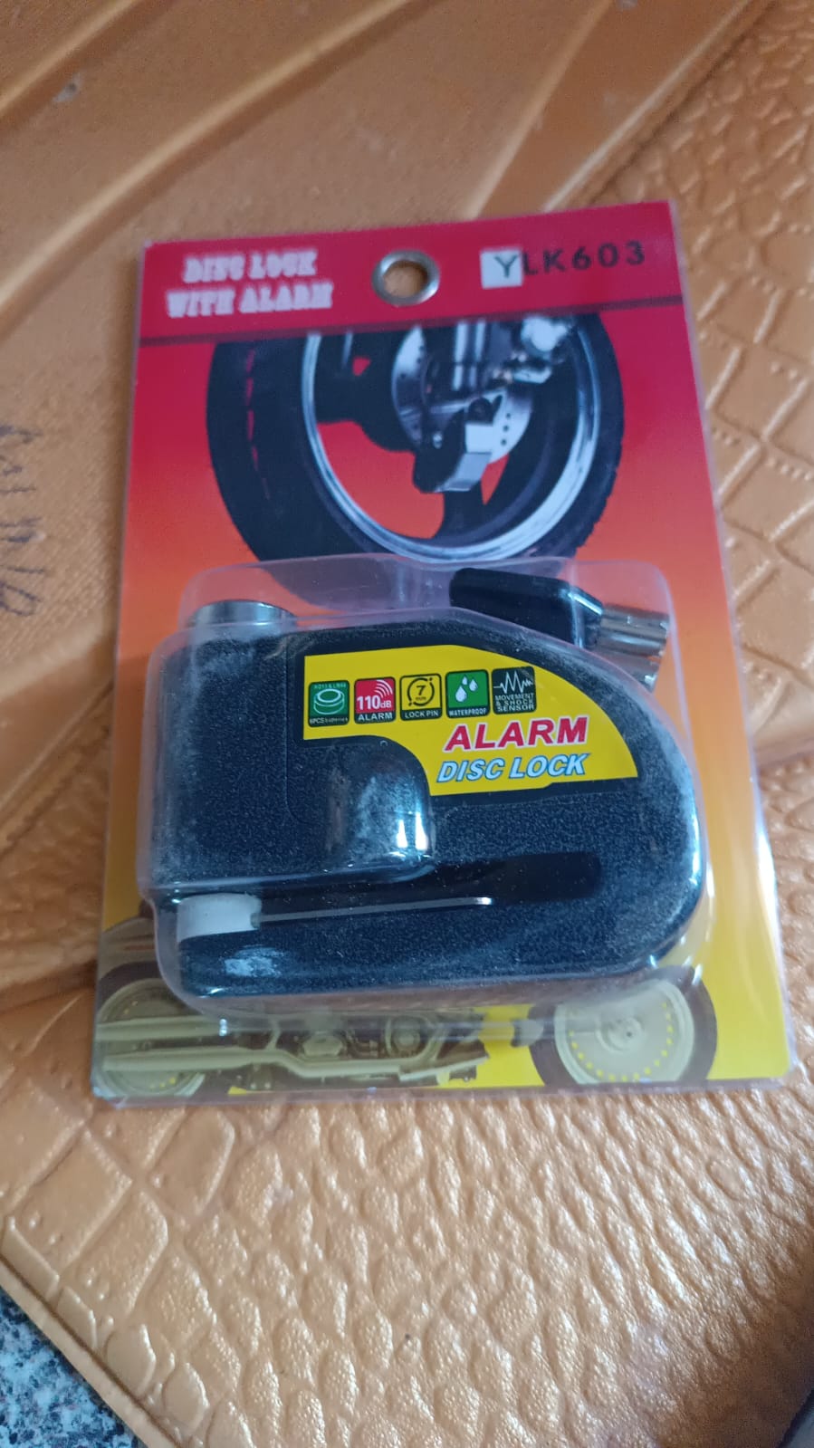 Diagram demonstrating installation of alarm disc brake lock