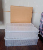 Three plastic fridge storage containers displayed on a wooden surface, highlighting their clear material.