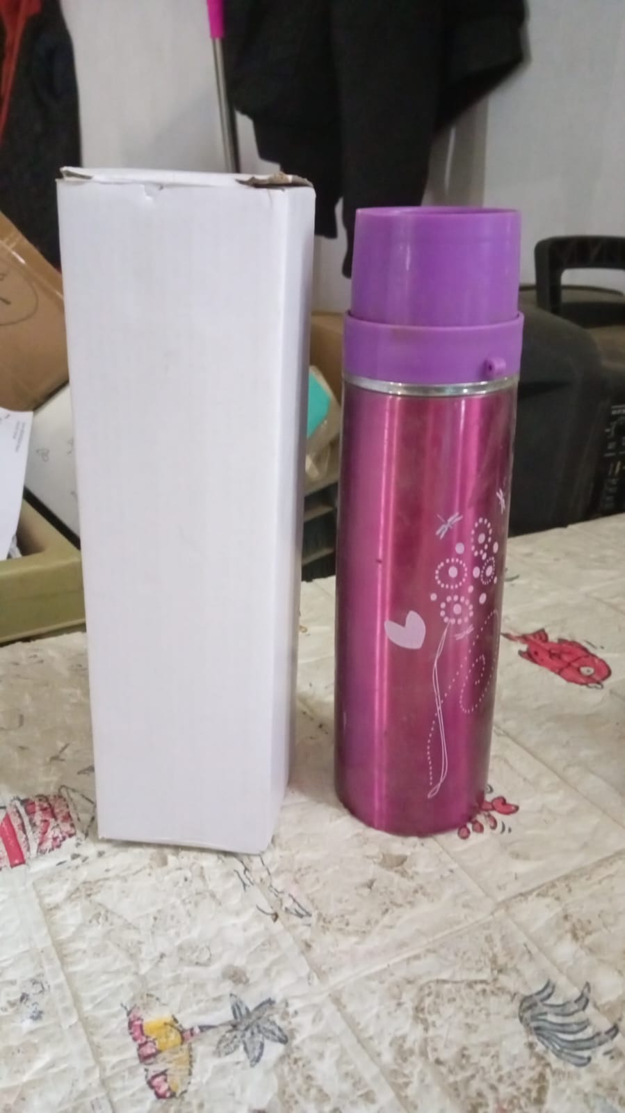 Stainless steel water bottle on a modern desk, promoting healthy office hydration.
