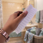 Durable plastic and nylon bristle cloth washing brush with ergonomic oval shape.