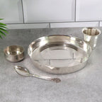 Close-up of the mirror-finish stainless steel thali plate.
