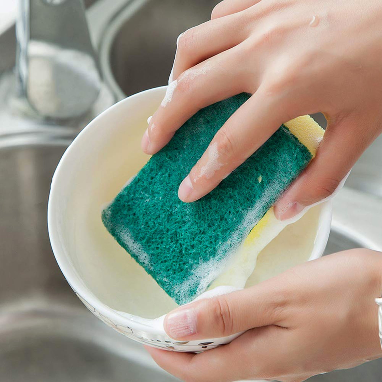 Durable scrub sponge effortlessly removing tough food stains from a kitchen dish.