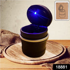 Close-up of blue LED illuminated car ashtray in cylinder shape