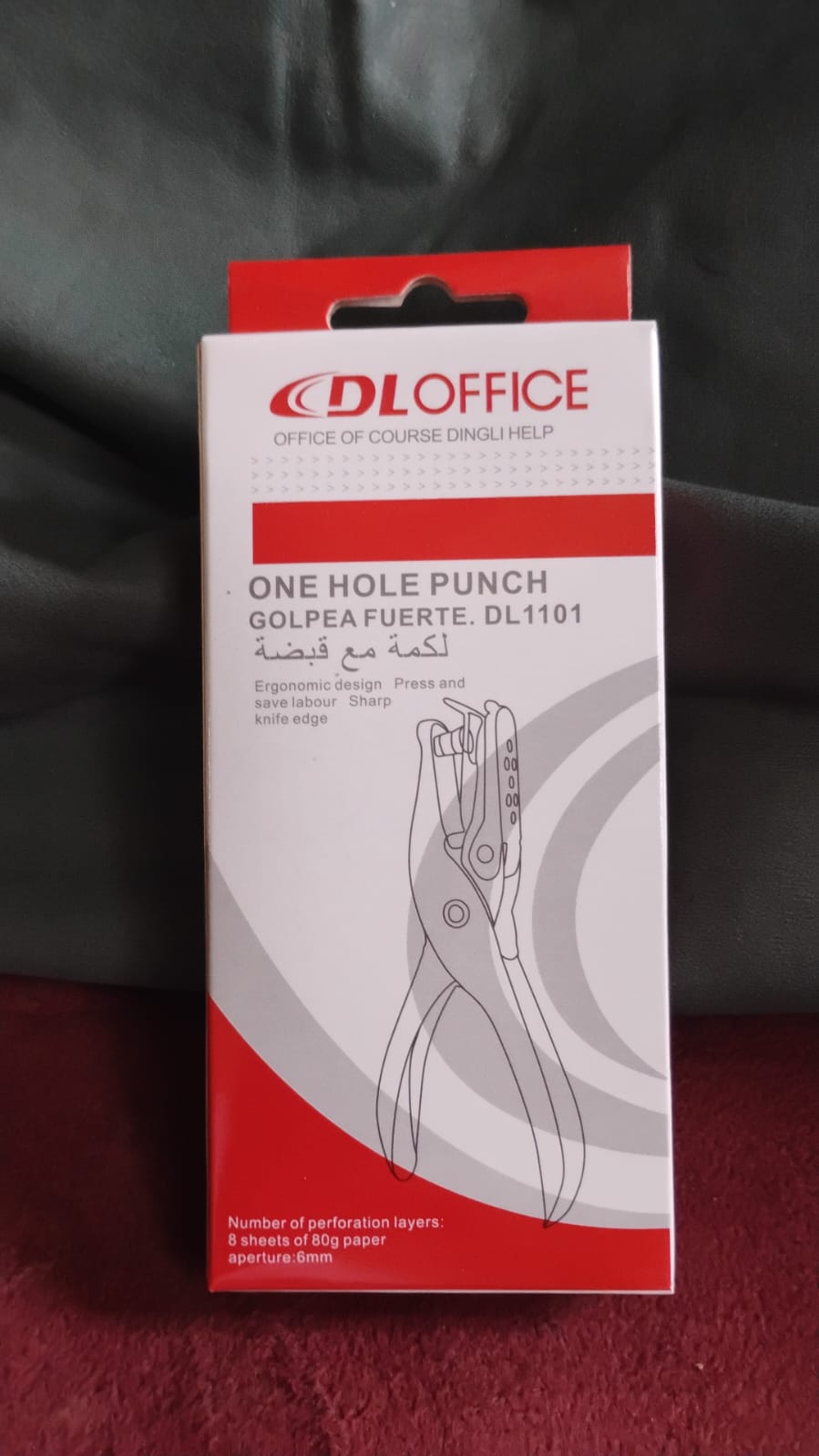 Portable single hole puncher showcasing its compact size for easy carrying.