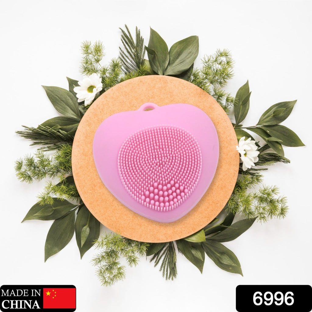 Heart-shaped silicone face wash brush for deep skin cleansing.