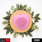 Heart-shaped silicone face wash brush for deep skin cleansing.