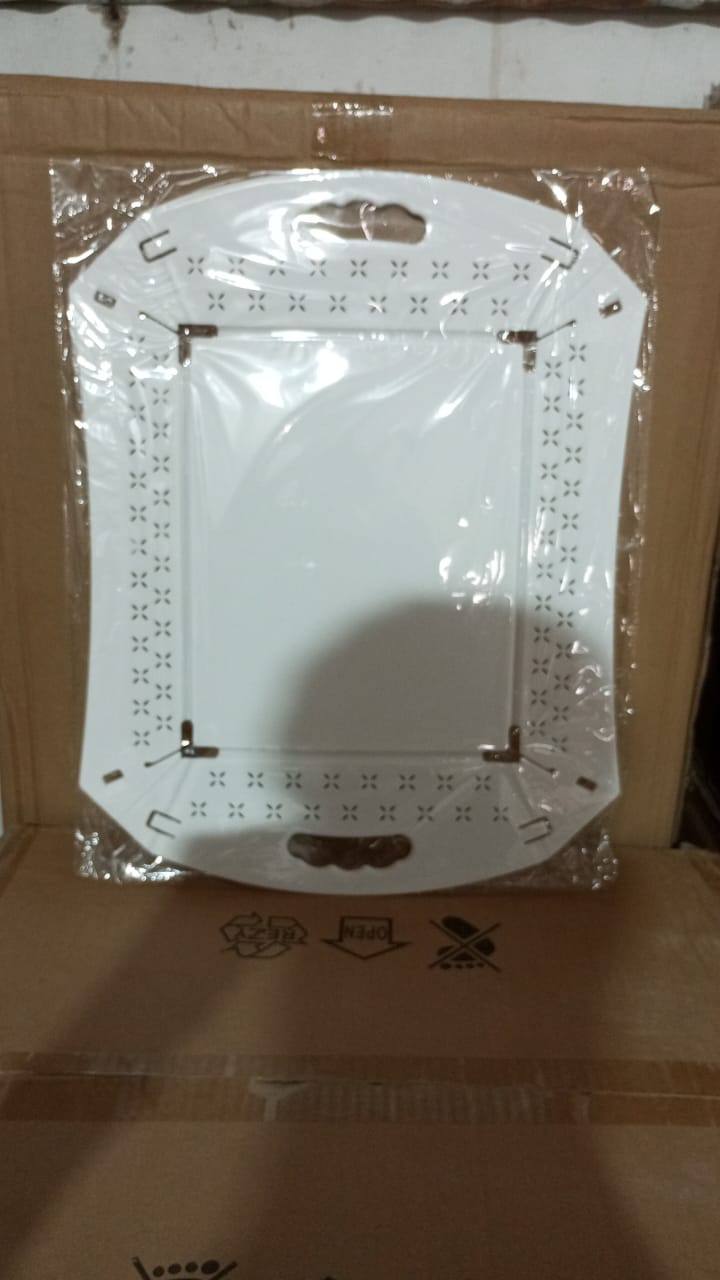 Compactly folded plastic serving tray, highlighting its space-saving design for easy storage.