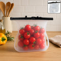 A clear Reusable Silicone Food Storage Bag standing upright, showcasing its leakproof seal and flat bottom design.