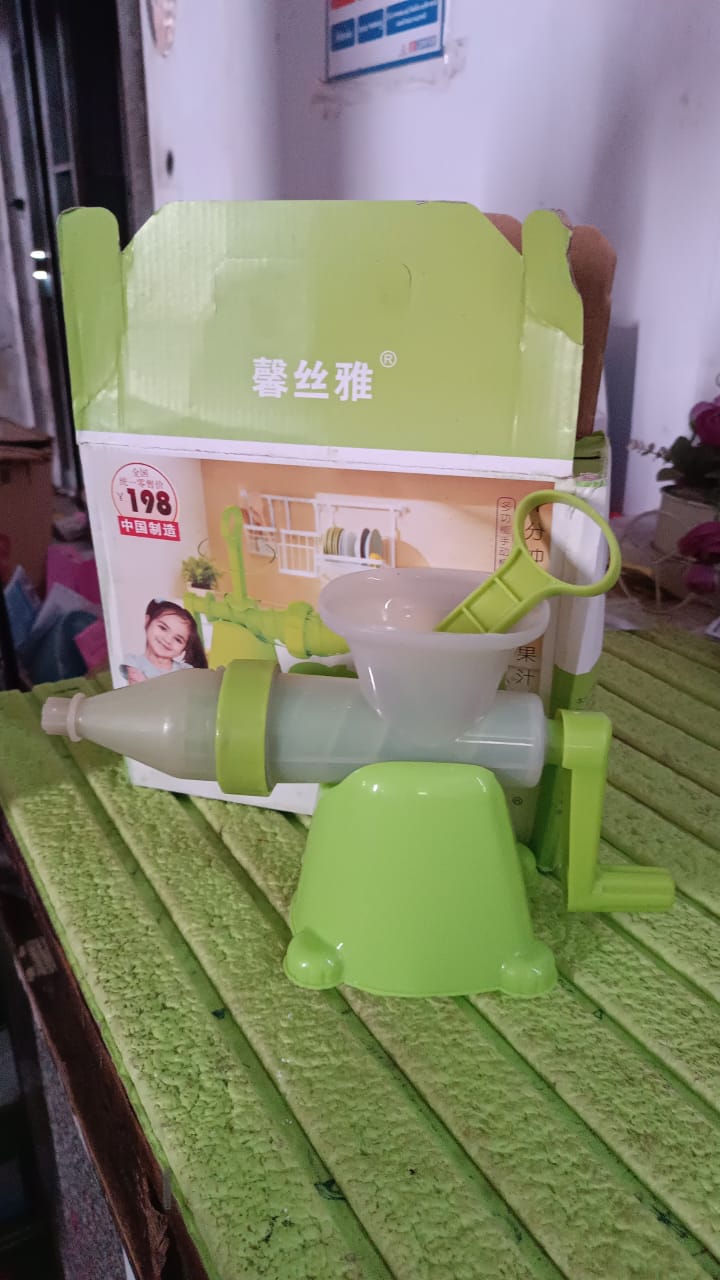 Angled view of manual juicer on white background