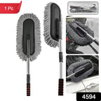 Hand using the soft Car Dust Brush to meticulously clean a car's dashboard without scratching surfaces.