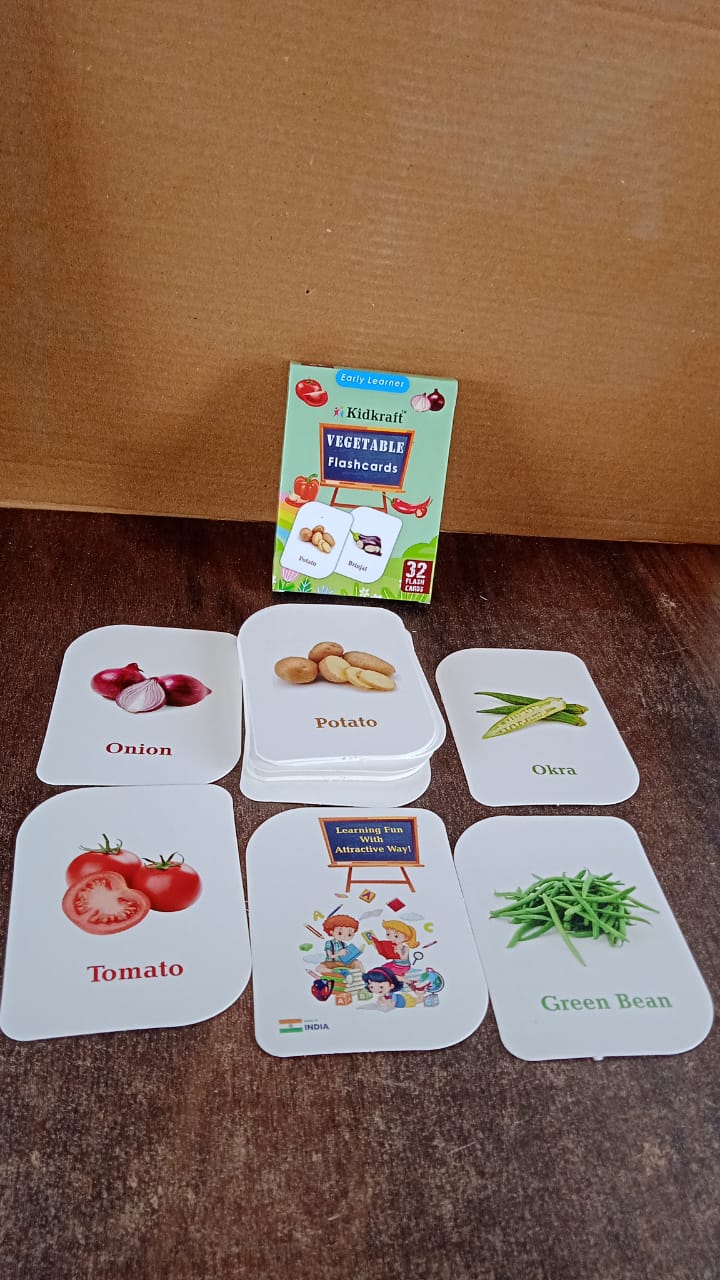 Assorted vegetable flash cards laid out for toddlers to learn vegetable names and images