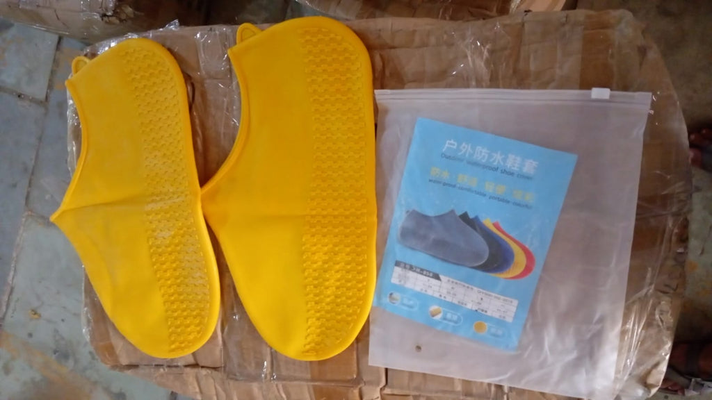 Waterproof silicone shoe covers worn over shoes in an outdoor setting.