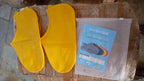 Waterproof silicone shoe covers worn over shoes in an outdoor setting.