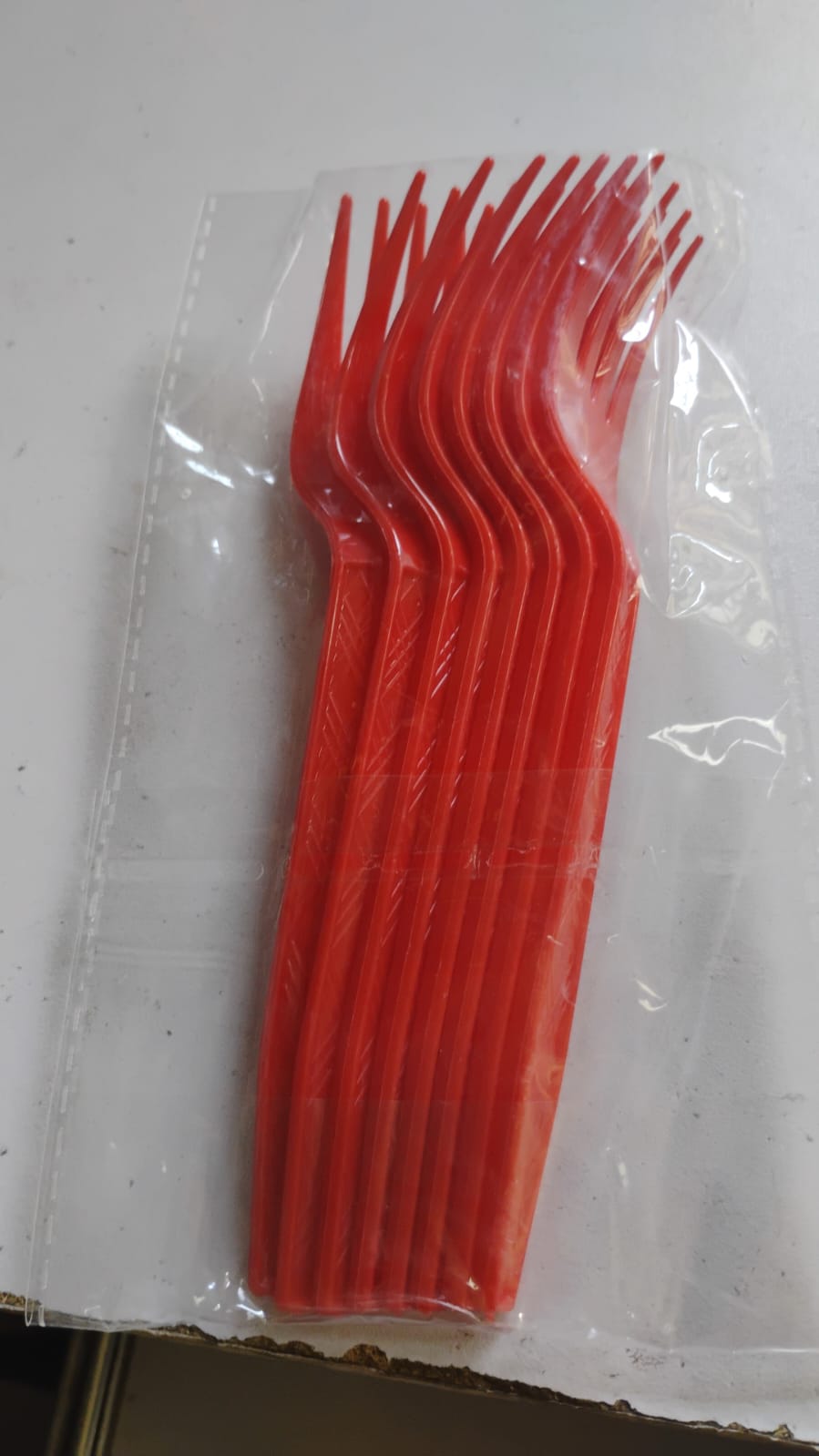 Close-up focus on red plastic disposable forks for party use