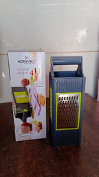 Easy-to-clean vegetable and fruit grater with cushioned grip, ready for washing.