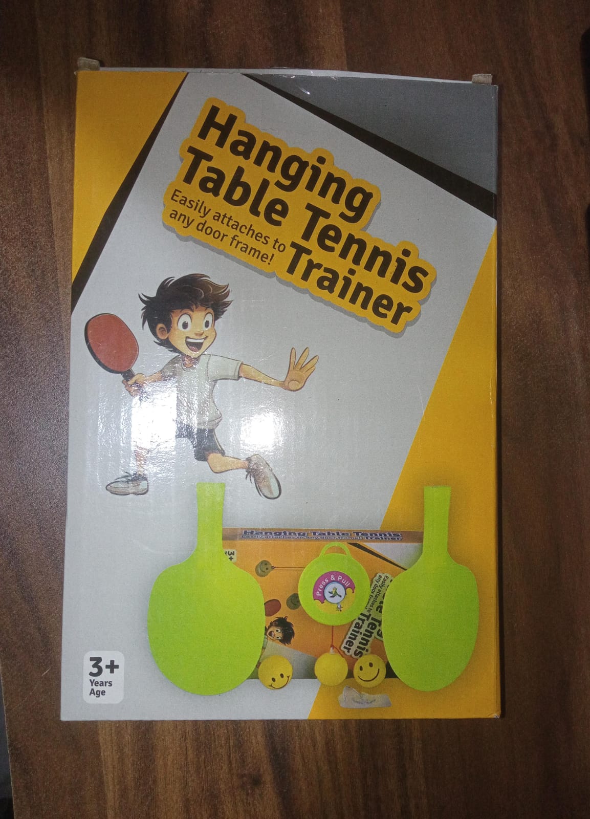 Packaging of the hanging table tennis trainer set, illustrating contents.