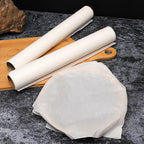 Non-stick baking paper roll displayed in a modern kitchen setting.