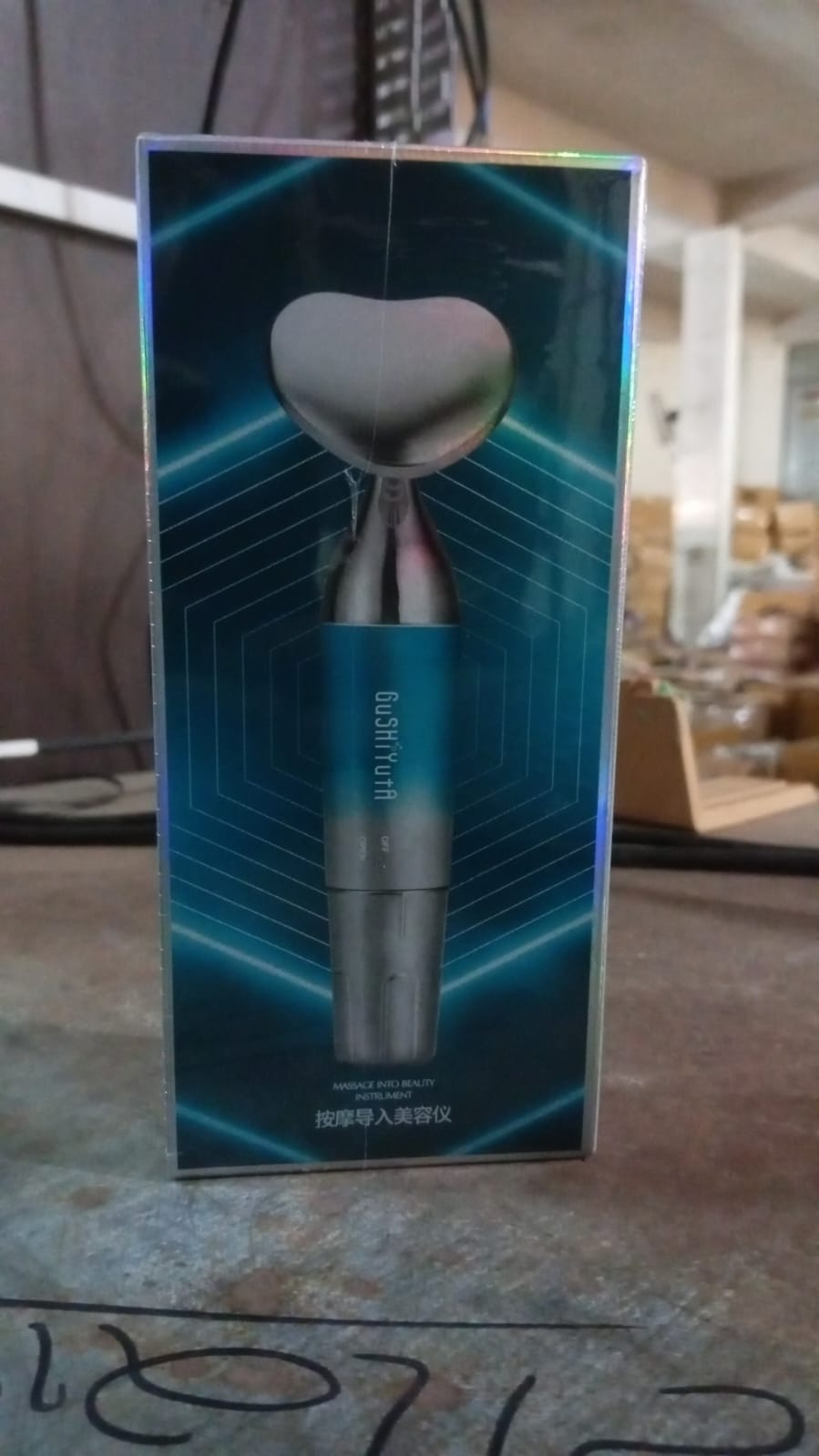 The compact facial beauty device in a woman's hand, ready for use.